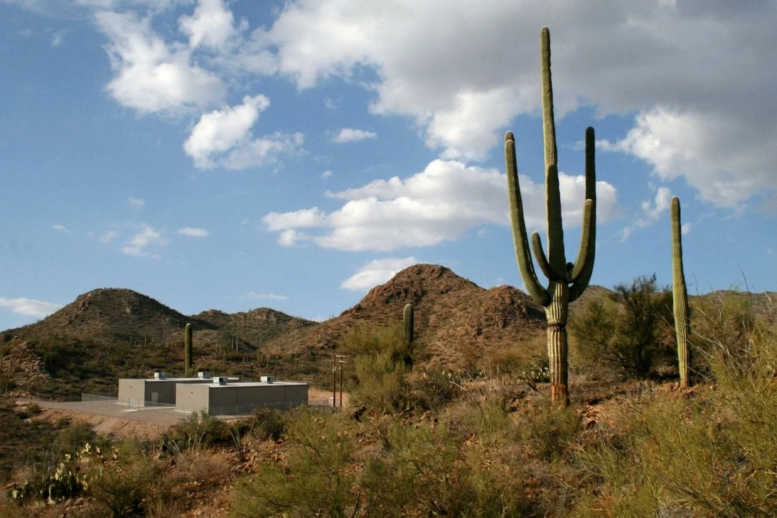 Illustrative Sonoran Desert scene with data center infrastructure on desert land